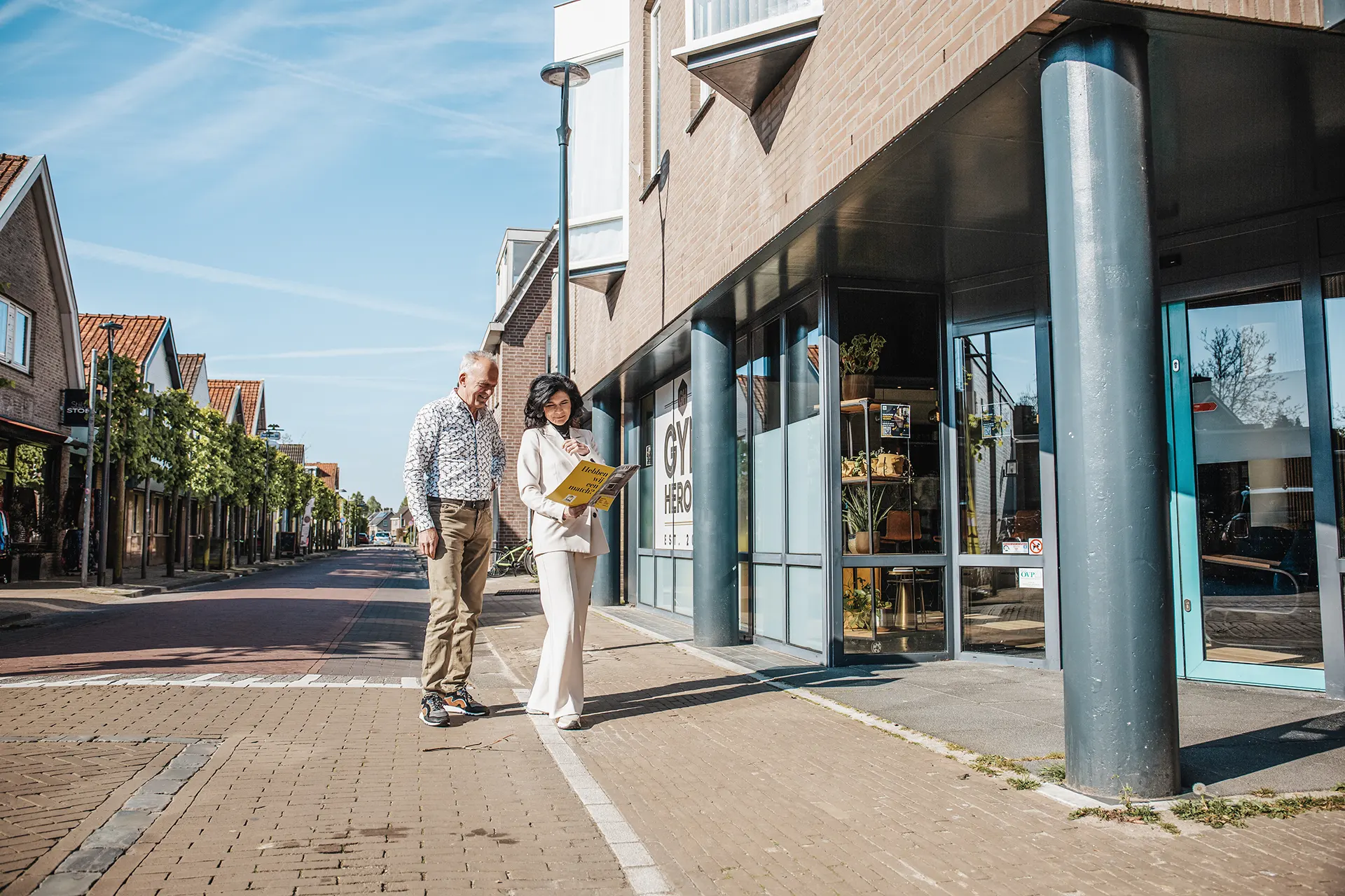 Mona staat met huurder voor een bedrijfspand tijdens een bezichtiging